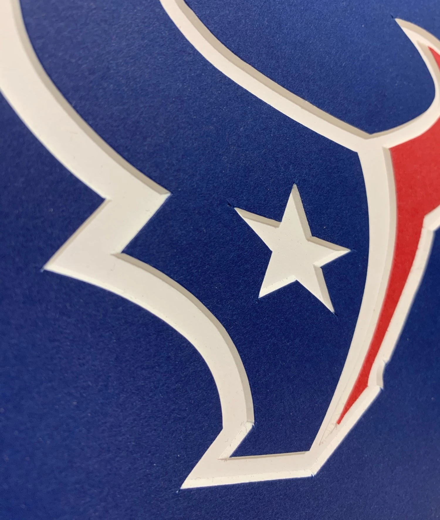 Close-up of custom-cut white mat details around blue and red graphic artwork