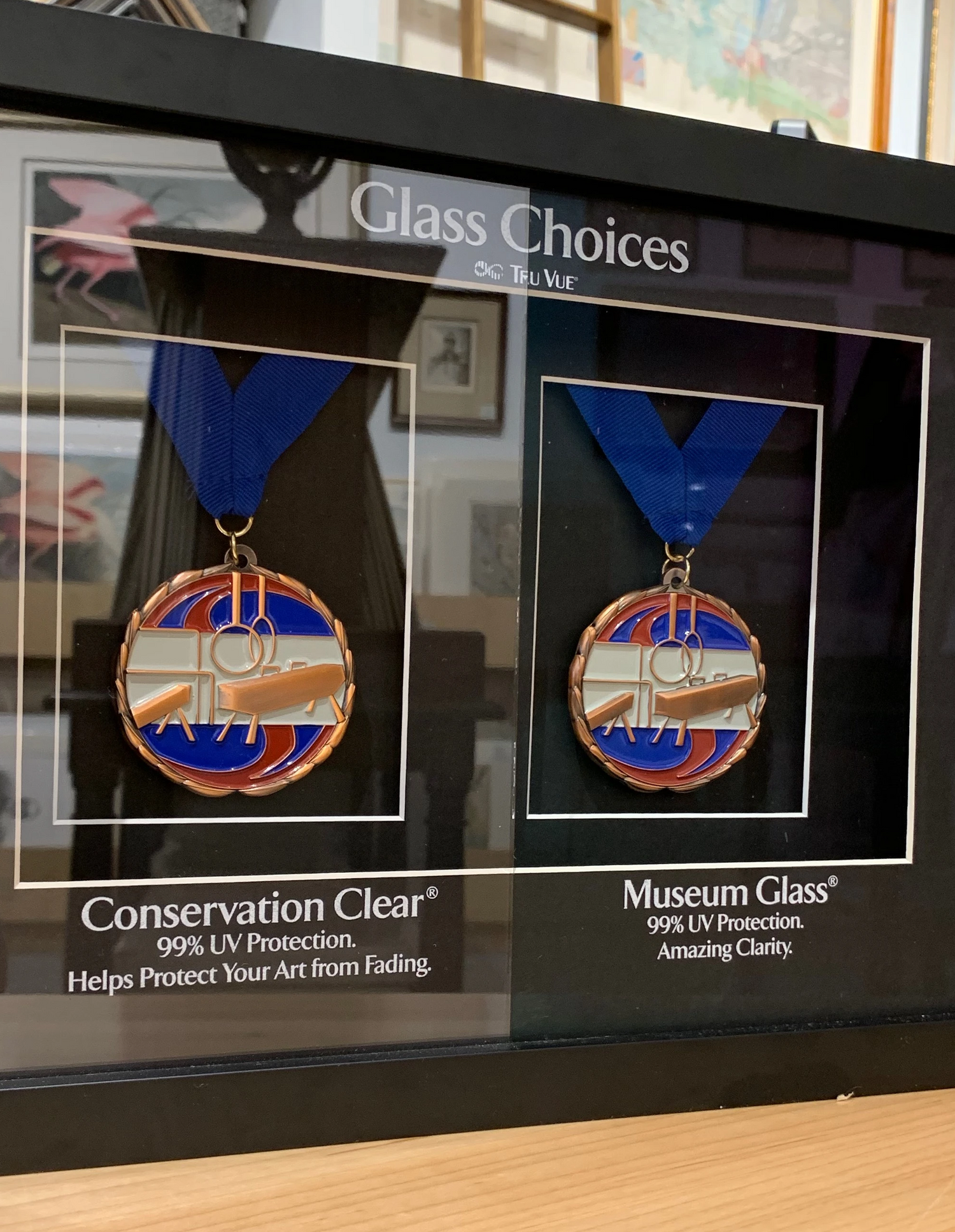 Side-by-side comparison of Conservation Clear and Museum Glass on framed medals